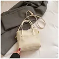 Chic beige textured fabric and leather crossbody bag on a classic grey suit jacket - No Pendant / White