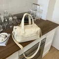 Chic beige Boston bag in litchi grain faux leather with top handles and shoulder strap - No Pendant / White