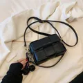 Black woven square crossbody bag with gold hardware and twin spherical charms - With Pendant / Black