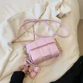 Pink woven crossbody bag with large grid texture and adjustable leather strap - With Pendant / Pink