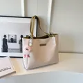 Borsa tote goffrata bianco crema con cinturini giallo senape e charm occhio peluche - Verde Liquirizia e Ciondolo
