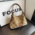 Beige canvas tote bag with M letter prints and brown leather handles and chain detail - Brown