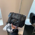 Quilted black crossbody bag with silver chain strap and fold-over twist lock closure - Black Small