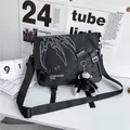 Black nylon messenger bag with white graphics and a monkey plush pendant - With Gorilla Pendant / Black