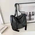 Minimalist black bucket bag with adjustable strap and vintage matte leather finish - Black