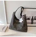 Detailopname van grijze vintage draagtas met modlabel en een pluche sterhanger - Met Hanger / Zwart