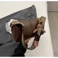 Vintage brown leather pillow bag with stylish geometric woven strap and bunny charm - Coffee With Charms
