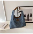 Detailed macro view of the blue washed canvas texture and brown leather strap of hobo bag - No Pendant / Blue