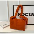 Detail of orange quilted crossbody bag with puff texture and soft nylon fabric finish - Orange