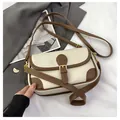 Dettaglio borsa a tracolla retrò color crema con finiture marroni e fibbie dorate - Bianco Sporco
