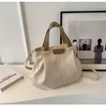 Detail of canvas tote bag with vertical pleats and dark brown leather accents - Off White