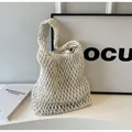 Detailed view of white woven rope tote bag with mesh texture and inner drawstring pouch - Off White
