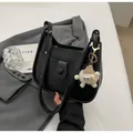 Detail of black leather bucket bag with cylinder clasp and cute plush charm pendant - Black