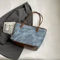 Chic marbled water blue tote bag with brown leather handles on a white backdrop - Blue Without Charm