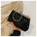 Elegant black sequin evening clutch with silver metal ring handle and rhinestone trim - Black