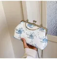 Elegant white lace evening bag with blue floral embroidery and round metal handle - Blue