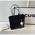 Black tote bag with heart embossed patterns and cute plush monster pendant on side - Black With Pendant