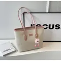 Off-white tote bag with pink trim, embossed cartoon patterns and a plush charm - Pink With Pendant