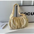 Detail of light yellow ruched shoulder bag with adjustable drawstring and fabric texture - Yellow