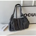 Close-up of deep grey pleated tote bag with drawstring details and soft fabric texture - Gray