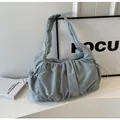 Detailed view of the light blue pleated cloud bag featuring a drawstring closure and soft texture - Blue