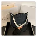 Black quilted crossbody bag with pearl handle and silver heart charm decoration - Black