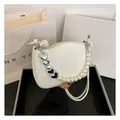 Sac bandoulière matelassé blanc avec chaîne à cœurs et perles dans un décor élégant - Blanc