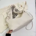 Minimalist beige cloud dumpling bag with pleated handle and thin shoulder strap - Off White