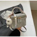 Sage green textured bucket bag with silk scarf handle and plush pompom charm - Silver