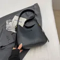 Minimalist black faux leather tote bag with vertical stitch and gold metal hardware finish - Black With Pendant