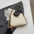 Minimalist cream and khaki shoulder bag with cute plush pendant on a grey jacket - Cream White with Pendant