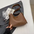 Brown faux leather shoulder bag with wide strap and white plush eyeball charm decoration - Brown with Pendant