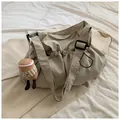 Minimalist beige drawstring bucket crossbody bag with cute plush pendant and wide strap - With Pendant / Off White