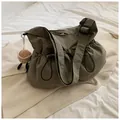 Army green nylon drawstring bucket bag with adjustable strap and plush coffee cup charm - With Pendant / Green