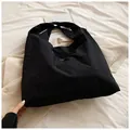 Grote zwarte nylon tote bag met wit minimalistisch logo en een getextureerde afwerking - Zwart