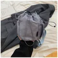 Detailed close-up of light blue nylon drawstring bucket bag with side mesh pocket and D-ring - Blue