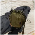 Army green nylon drawstring bucket bag with mesh side pocket and adjustable strap - Green