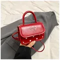 Red mini crossbody bag with white polka dots and golden bow knot metal buckle detail - Red
