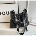Quilted black hobo bag with glossy finish and patterned wide canvas shoulder strap - Black