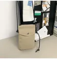 Dettaglio della mini borsa a tracolla in nylon con bottone a pressione in metallo e zip - Kaki