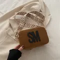 Brown suede crossbody bag with SM logo and wide geometric pattern woven shoulder strap - Brown