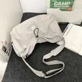 Light grey ruched nylon crossbody messenger bag with adjustable wide black shoulder strap - Gray