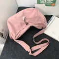 Pink nylon crescent crossbody bag with adjustable strap and drawstring detail - Pink