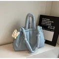 Close-up of light blue quilted tote bag with soft texture and plush charm accessory - Blue with Pendant