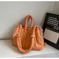 Bolso bandolera acolchado naranja con asa acolchada y cordón sobre superficie de mármol - Naranja Sin Colgante