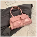 Detail of pink glossy leather handbag with double front pockets and silver hardware - Pink
