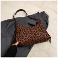Detail of leopard print tote bag featuring a brown leather strap with unique knot design - Coffee Leopard