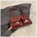 Deep burgundy glossy PU leather handbag with dual front pockets and shoulder straps - Red