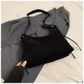 Minimalist black suede hobo bag with side drawstring detail and adjustable wide strap - Black