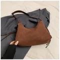 Brown frosted leather hobo shoulder bag featuring stylish side tassels and zipper closure - Coffee